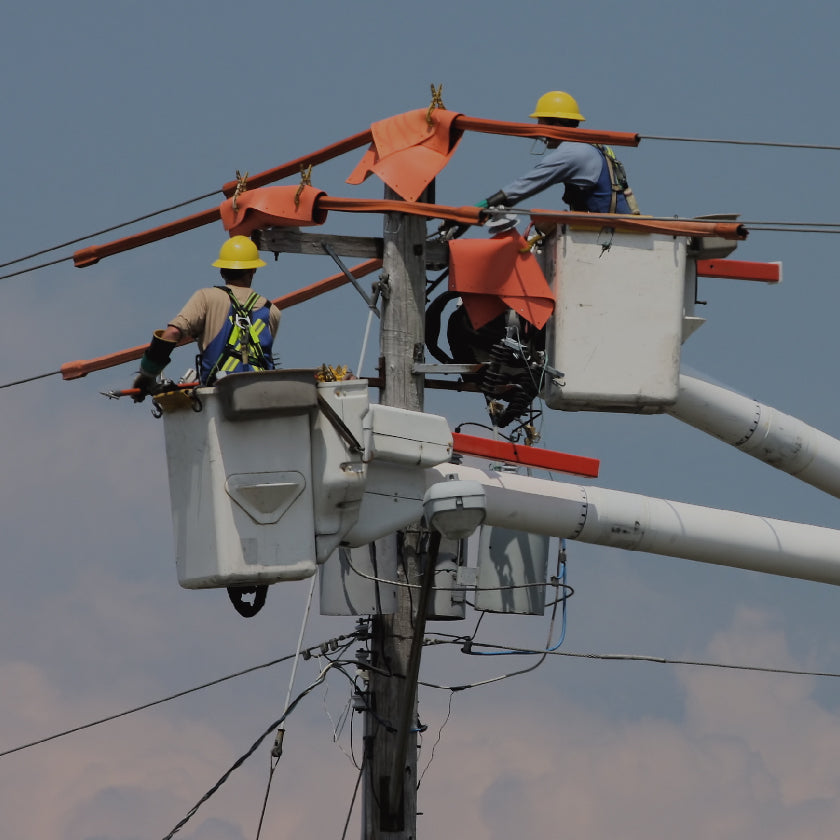 Power company linemen working on power pole